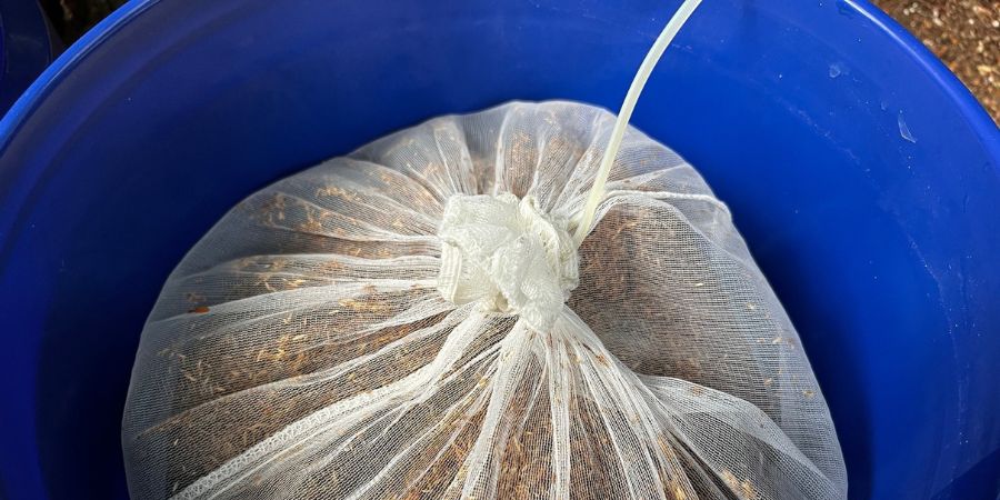 grass seed in bag in blue bucket